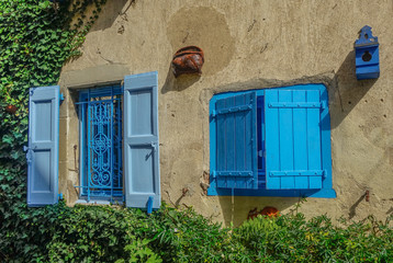 Revel, Midi Pyrenees, France - August 5, 2017: Two open blue rustic windows on a sunny day - Powered by Adobe