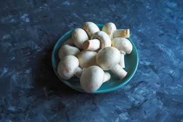 Mushrooms in a bowl on a black table.
