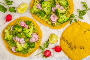 Vegan tacos (pizza, pita) with radish, broccoli and guacamole, top view. Healthy vegan food concept.