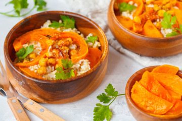 Vegan buddha bowl with brown rice, baked pumpkin and chickpeas. Vegetarian food concept.