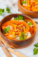 Vegan buddha bowl with brown rice, baked pumpkin and chickpeas. Vegetarian food concept.