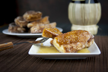 Traditional Spanish torrijas on dish and fork