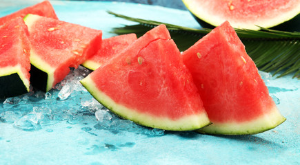 watermelon on blue background. juicy summer fruit in slices
