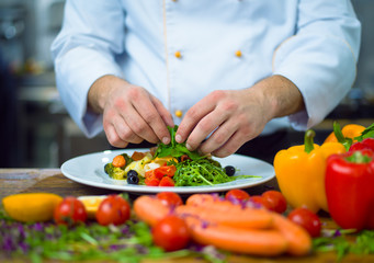 cook chef decorating garnishing prepared meal