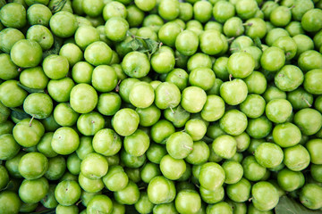 green ripe plums in the market 
