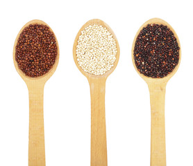 Black red white quinoa seeds in wooden spoon isolated on white background. Top view