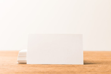 close up view of blank cards on wooden surface on grey backdrop