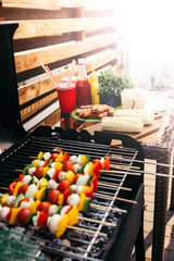 Seasonal vegetables and mushrooms on skewers cooked outdoors on grill