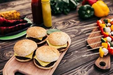 Hot delicious burgers and vegetables grilled for outdoors barbecue