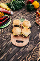 Cut vegetables and burgers grilled for outdoors barbecue