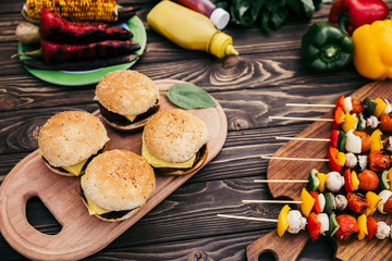 Seasonal vegetables and burgers grilled for outdoors barbecue