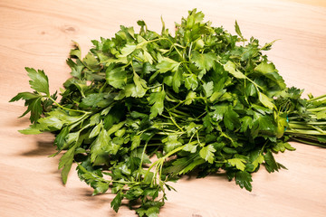 bunch of fresh parsley on a wooden board