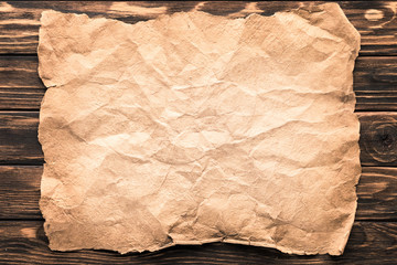 top view of blank crumpled paper on rustic wooden surface