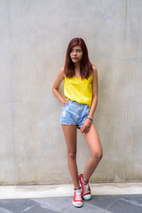 Beautiful teenager girl wearing vibrant yellow shirt