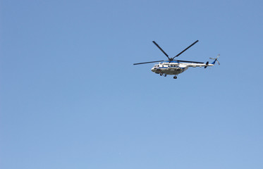 Naklejka na ściany i meble Close up of helicopter in the sky