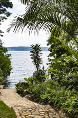 Stone Pathway through the Palm Trees and Garden to Laguna de Apoyo Lake inside an Extinct Volcano Crater in Nicaragua