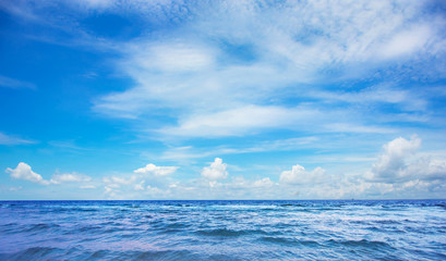 Adorable little kid boy with toys and playing with sand on beach, sea and sky view