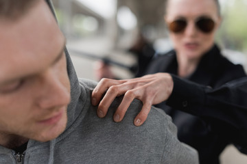 close-up shot of policewoman catching shoulder of thief