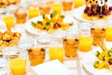 Banquet table with snacks and drinks close