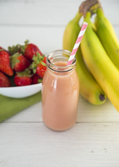Strawberry Banana Fruit Smoothy on a White Wood Table