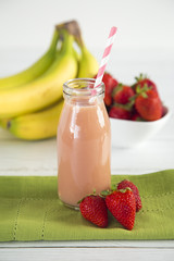Strawberry Banana Fruit Smoothy on a White Wood Table