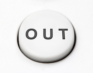 A white round button switch - out, close up. Control mechanical key for exit on control device.