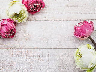 Pink lotus flowers on wooden table.