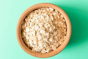 A bowl of cereal on a turquoise background. The concept of healthy food