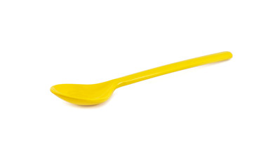 Yellow spoon isolated on white background