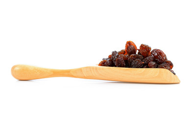 raisin on wood scoop isolated on white background