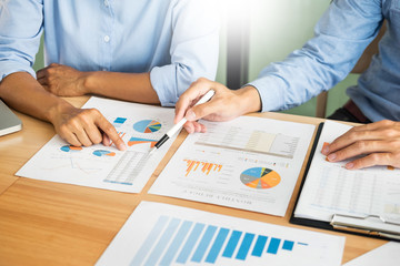 Business team hands at working with plan on office desk and modern digital computer laptop....