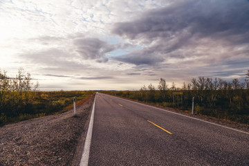 North Norway, evening with sunset on a long road near Kautokeino on a summer day
