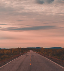 North Norway, evening with sunset on a long road near Kautokeino on a summer day