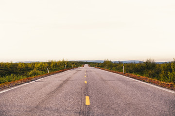 North Norway, evening with sunset on a long road near Kautokeino on a summer day