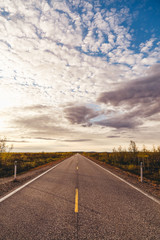 North Norway, evening with sunset on a long road near Kautokeino on a summer day