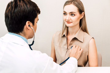 Doctor examining female patient with stethoscope in the hospital.healthcare and medicine