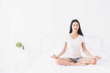Obraz na płótnie Canvas Woman practicing yoga at home in bedroom