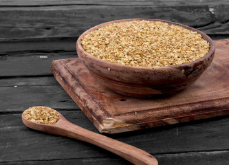 Split Roasted Coriander Seeds in Wooden Bowl also know as Dhana Dal or Sukh Mukh on Wooden Table
