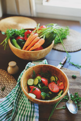 fresh salad with cucumbers and tomatos picked from farm garden. Seasonal summer harvest.