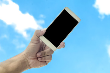 hand holding smartphone isolated on sky background