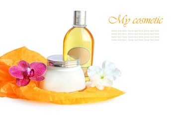 cosmetics set with orchid and petunia flowers on white background. composition
