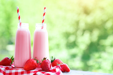 Strawberry cocktail or milkshake in a jar on a picnic, healthy food for Breakfast and snacks.