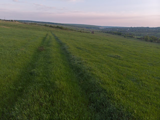 Road in the field on the sunset