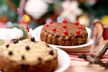 Fototapeta na wymiar Christmas chocolate tart pie with berries. Raw vegan vegetarian healthy food concept.