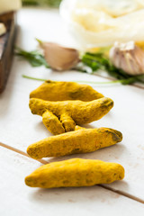 Yellow dried turmeric root spice. Ayurvedic indian ancient ingredient. Raw, vegan, vegetarian, healthy food concept.