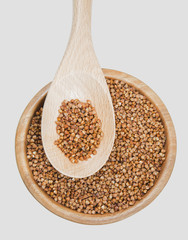 buckwheat in a spoon on white background