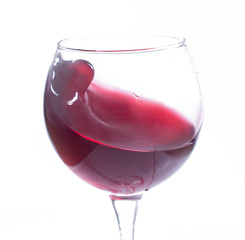 A glass with red wine on a white background. Isolate
