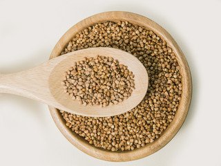 buckwheat in a spoon on white background