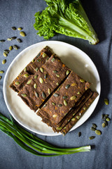Dehydrated raw vegan dry breads with pumpkin and flax seeds. Healthy food concept.