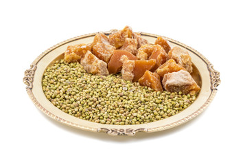 Group of jaggery with Coriander Seeds also Know as Gur, Goor or Gud isolated on White Background